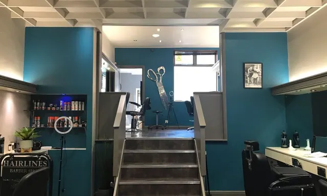 Inside Amanda's Barber House, looking up the steps to the chairs